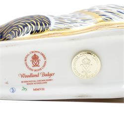 Three Royal Crown Derby paperweights, comprising two of Bramble the Hedgehog, with gold stopper, with boxes, and one of a Woodland Badger, with gold stopper, boxed (3)