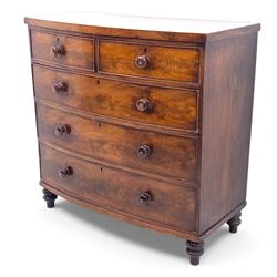 19th century bow front mahogany chest of drawers, rectangular top with moulded edge above an arrangement of two short and three long graduating drawers with turned wooden handles, raised on turned feet