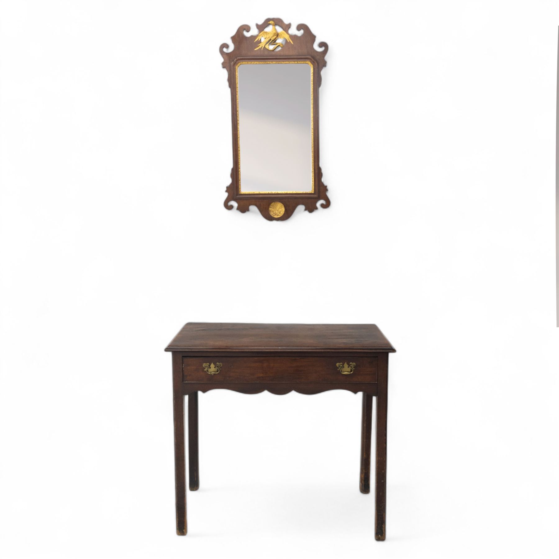 George III mahogany side table, the rectangular moulded top above a single frieze drawer fitted with brass swan neck handles, above a shaped serpentine apron raised upon square section legs, W86 D42 H75cm, together with a George III fretwork mirror, the rectangular plate within a gilt slip surmounted by a pierced crest with inset carved Ho-Ho bird, with shaped apron with gilt shell motif, H84cm W45cm