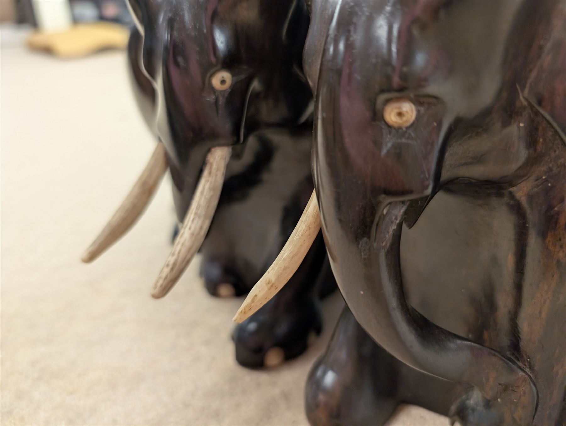 Pair of carved elephant bookends with bone tusks, H14.5cm