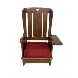 Arts and Crafts design oak reading wingback armchair, high back with pierced heart design, drop-leaf side table to one arm