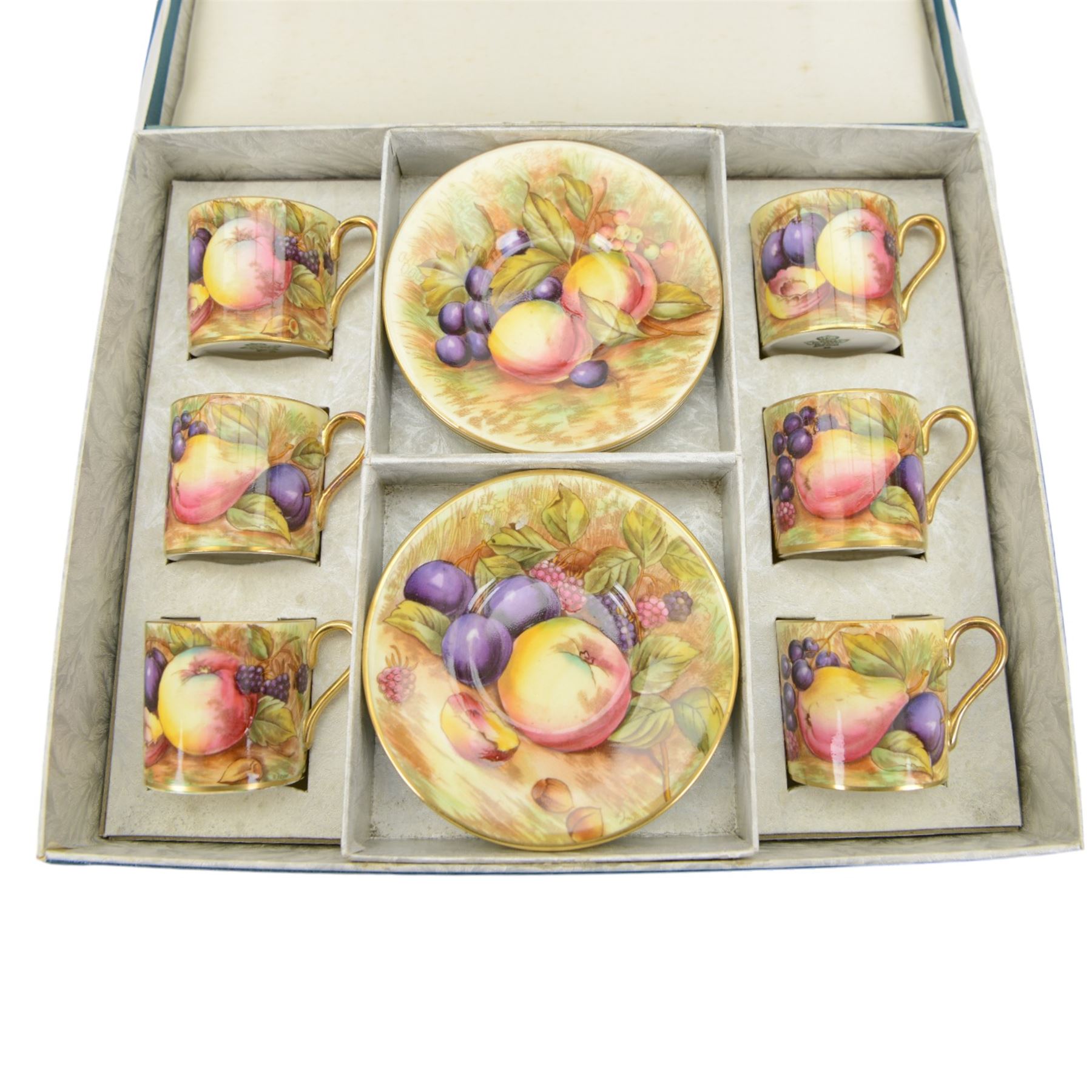 Aynsley fruit pattern, set of six coffee cans and saucers, gilded and decorated with fruit signed by N Brunt, in the original box, can H6cm