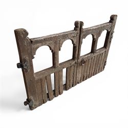Pair of 19th century weathered wooden ecclesiastical church gates, the cresting rail over four pierced arches with slatted lower section, fitted with heavy cast iron hinges, latch and fittings