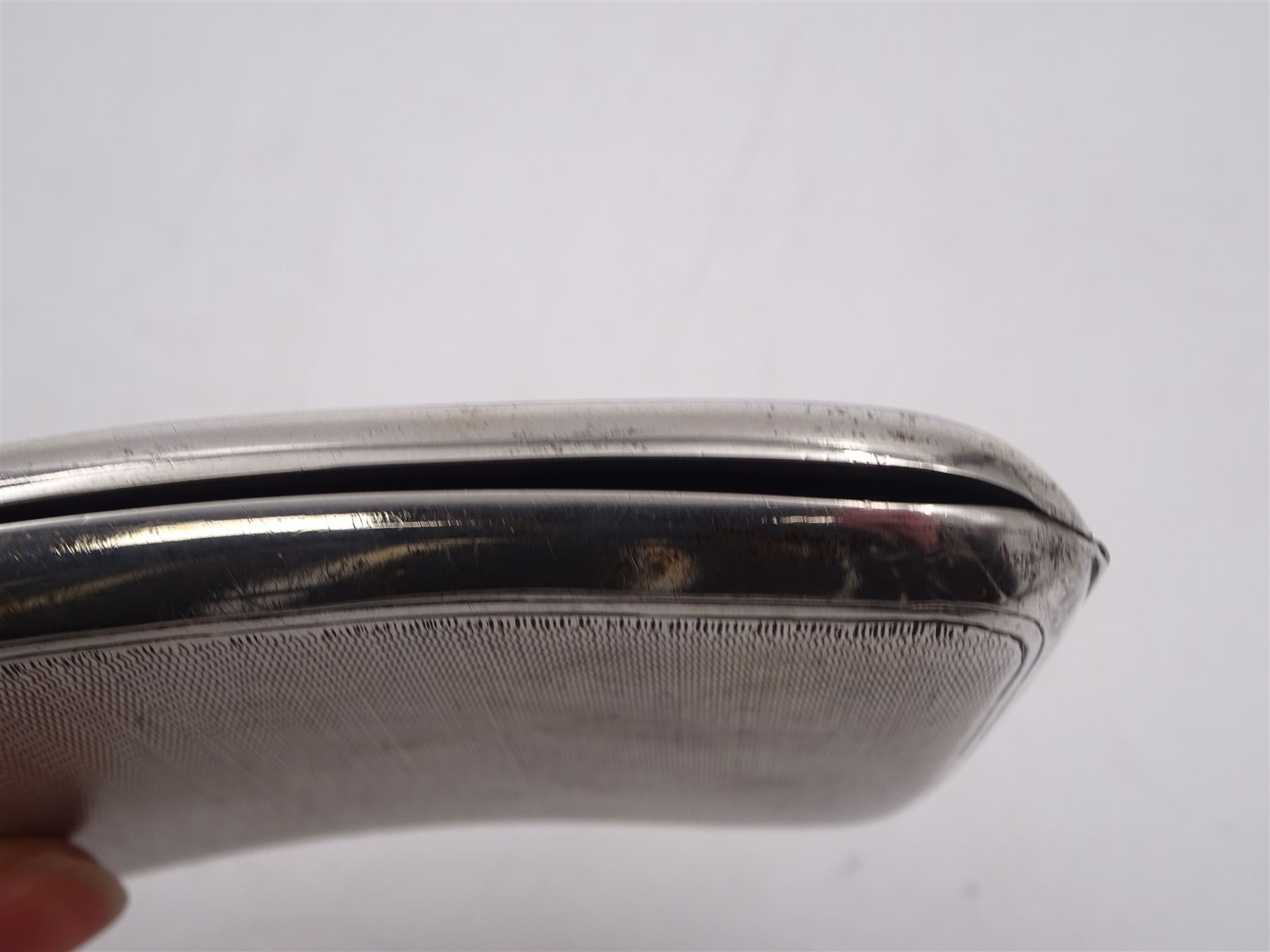 Edwardian silver cigarette case, of rectangular form with engine turned decoration throughout and engraved cartouche to front cover, hallmarked Colen Hewer Cheshire, Chester 1906, H8.6cm