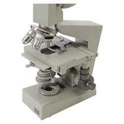 Three microscopes, including Griffin Student Vernier Microscope, Vickers Instruments binocular microscope with Leitz Wetzlar Periplan 10x lenses, and a Carl Zeiss Jena binocular microscope in a wooden Olympus Tokyo box