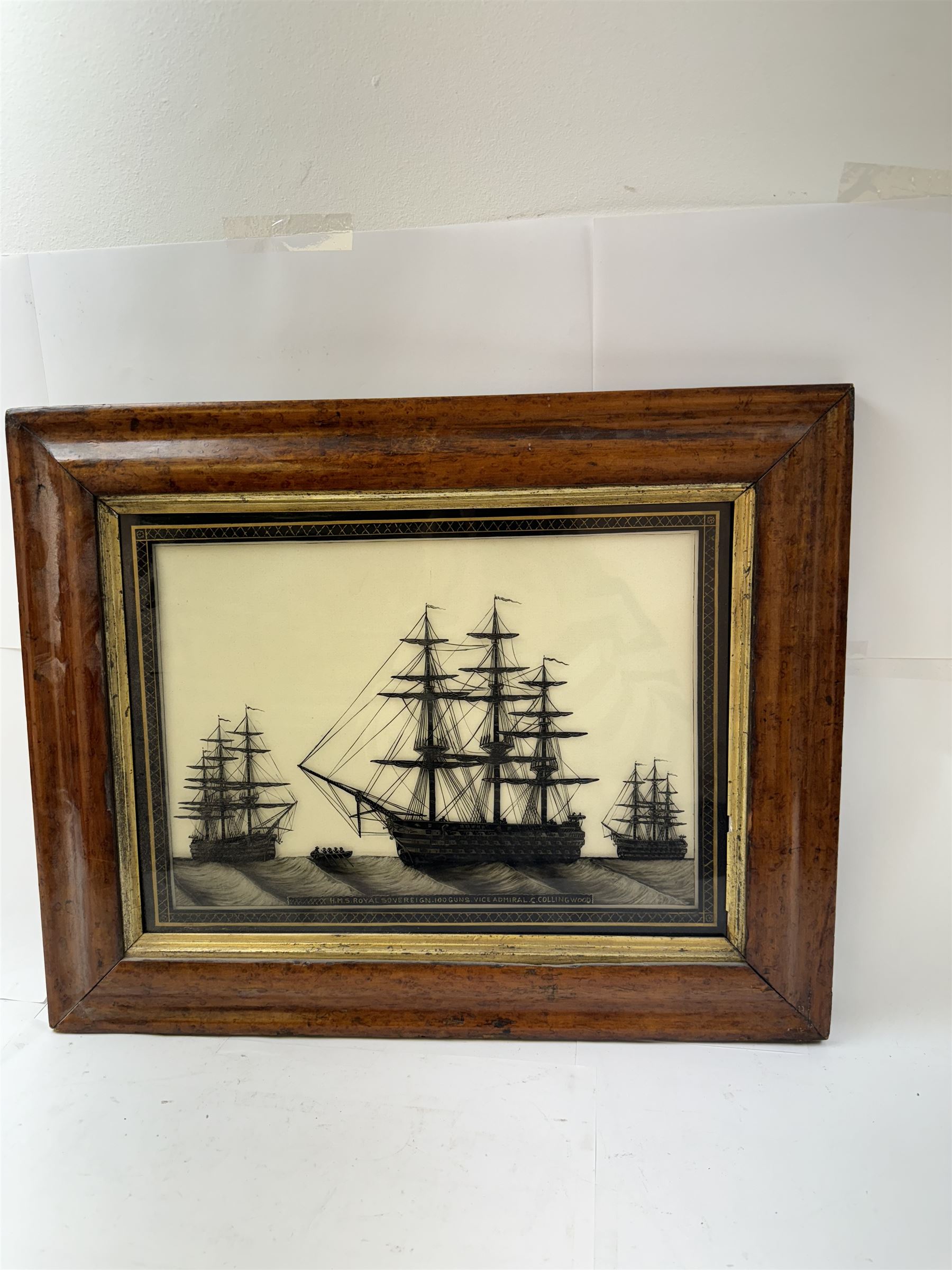 19th century monochrome ship silhouette, reverse painted on glass, within Verre Eglomise border inscribed 'HMS Royal Sovereign 100 Guns Vice Admiral C.Collingwood', in a birds eye maple frame, painting H31cm, W41cm
