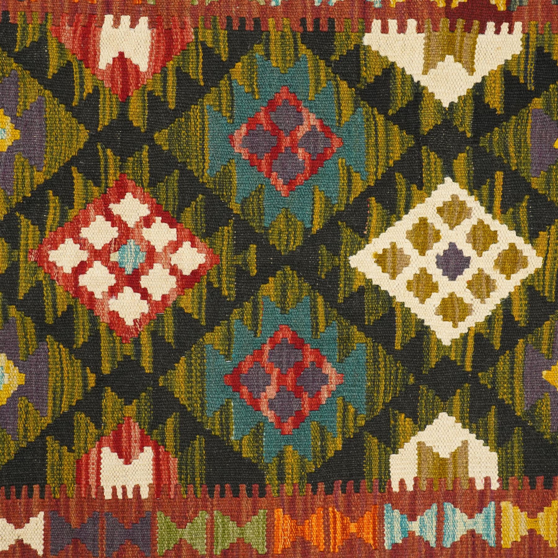 Afghan Maimana flatweave kilim runner, central field features large bold nested diamond motifs and stylized geometric lozenge patterns on olive purple, blue, and green tone ground, border stripe in green ground, and fringe