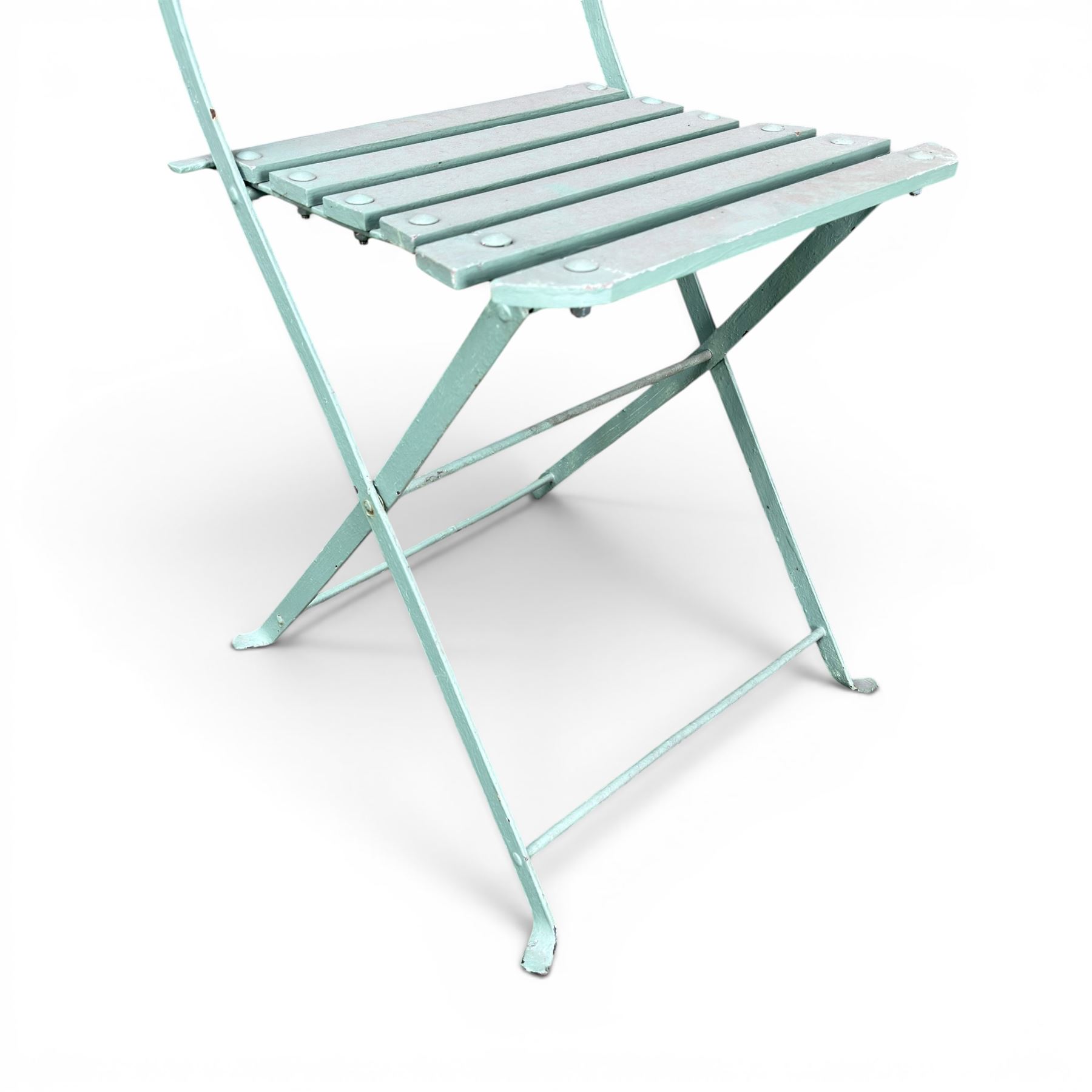 Wrought metal folding garden table, with painted wood plank top; and four matching folding chairs
