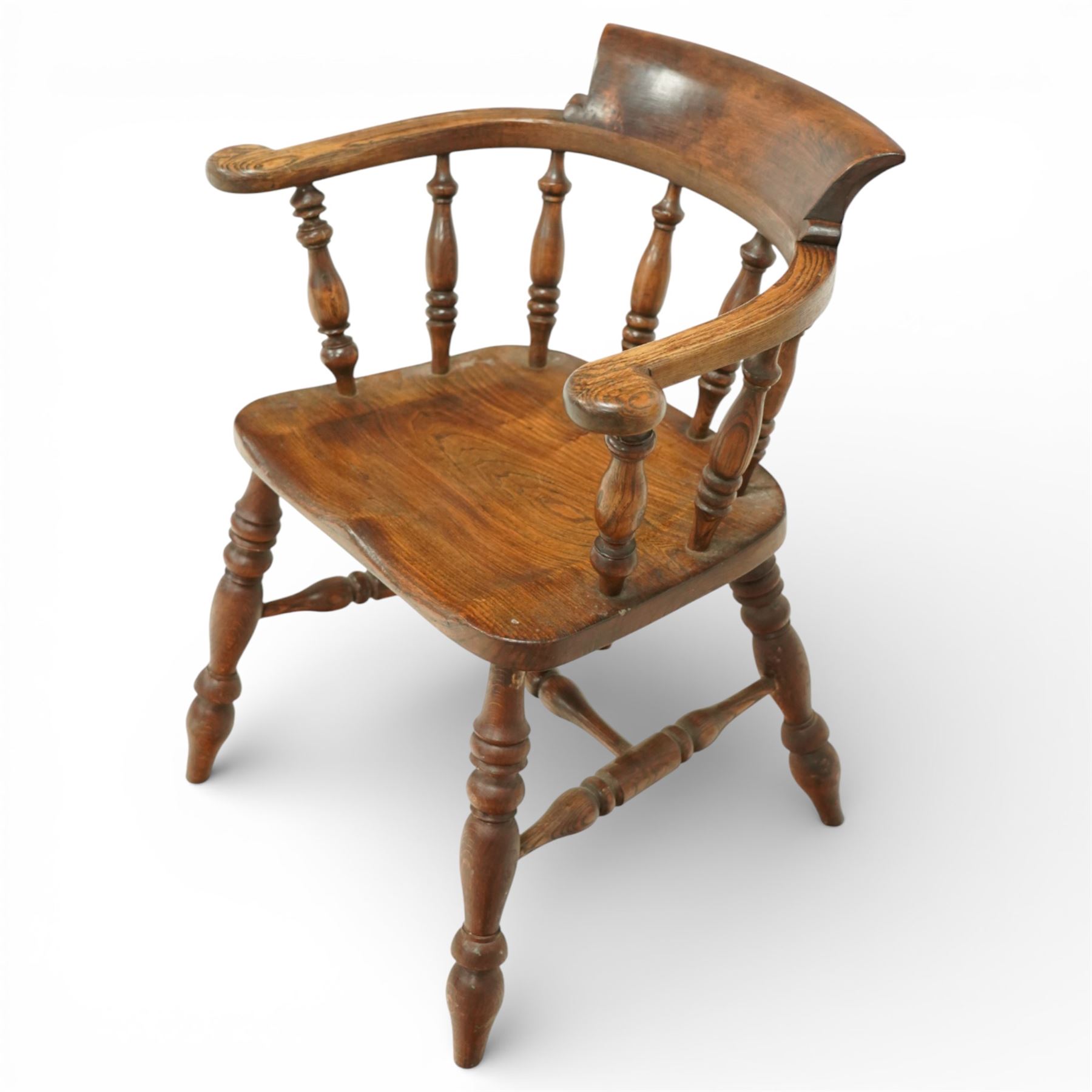 20th century captain’s oak smoker’s chair, with curved horseshoe back rail, turned spindle supports, shaped solid seat, turned legs united by stretchers