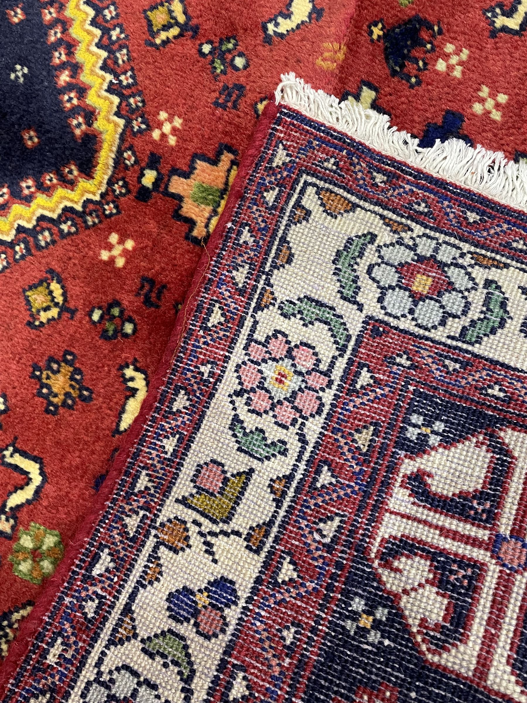 Small Persian Abadeh rug, blue ground with red lozenge field decorated with small bird and plant motifs, triple band border with floral design