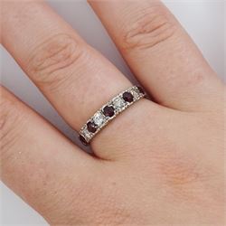 White gold garnet and diamond half eternity ring, nine alternating round brilliant cut diamonds and round cut garnets, stamped 18ct, total diamond weight approx 0.30 carat