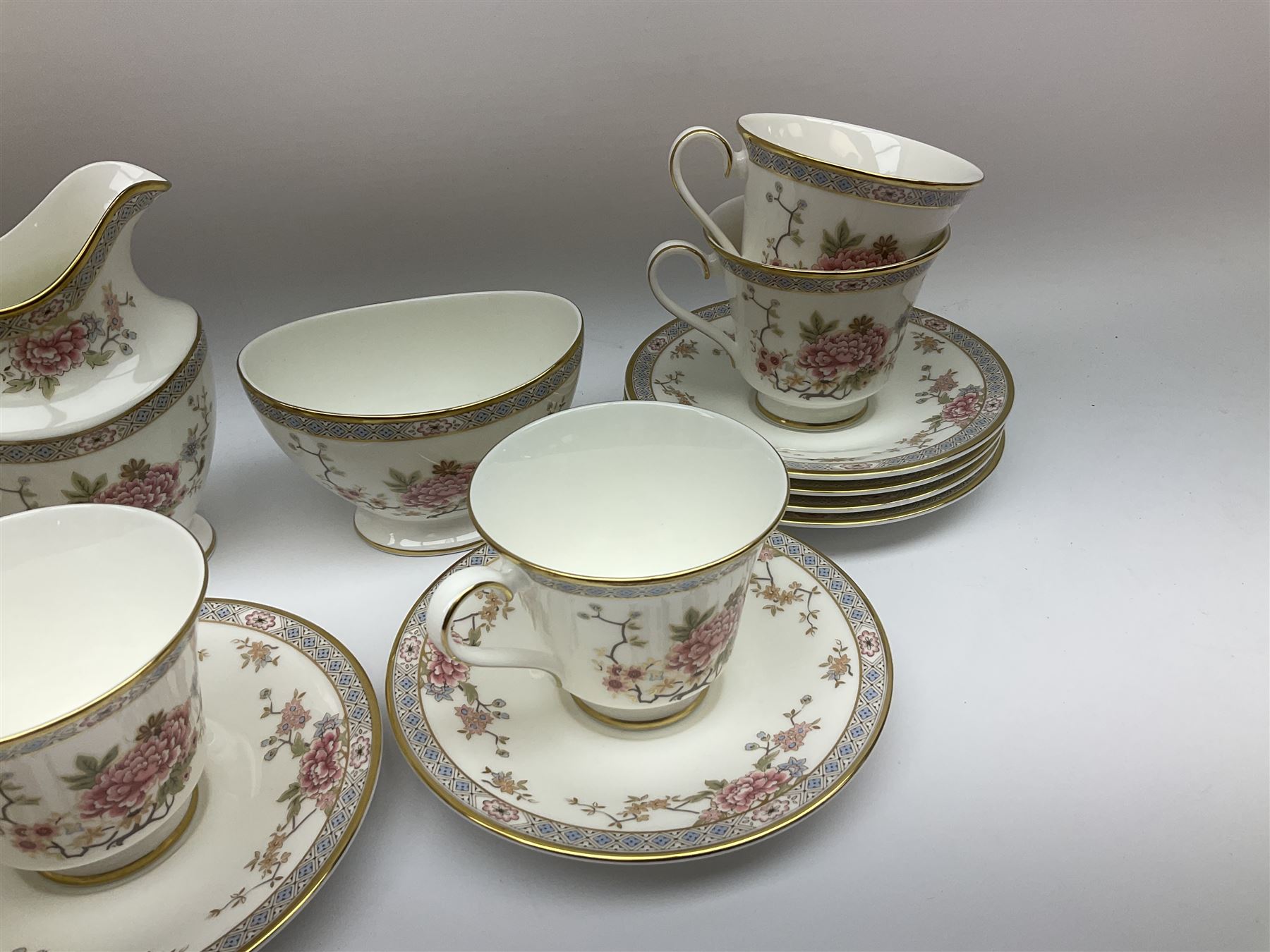 Wedgwood Queens Ware tea and dinner wares in Provence pattern, including ten cups and saucers, milk jug, butter dish with cover, ten dinner plates, ten bowls and ten side plates etc (71), together with Royal Doulton tea wares in Canton pattern, comprising six cups and saucers, milk jug, open sucrier and six dessert plates.    