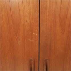 G Plan - 'Fresco' teak double wardrobe, twin doors enclosing a single clothes rail, on a recessed plinth base with castors beneath  