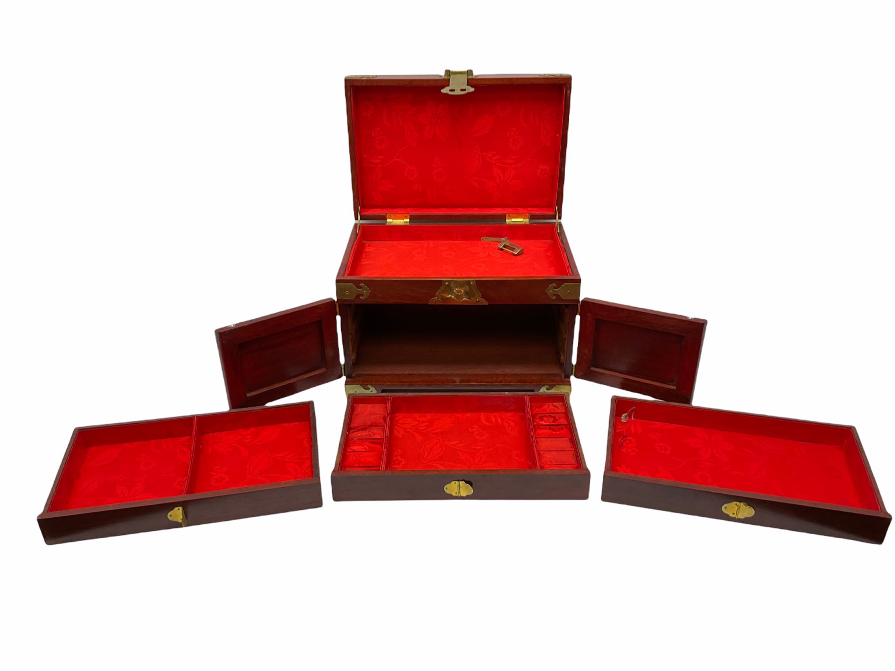 Chinese hardwood jewellery box mounted with engraved brass fixtures, the two exterior doors revealing three drawers below the hinged upper lid, lined with red material decorated with floral sprays, H25cm, W36cm, D23cm