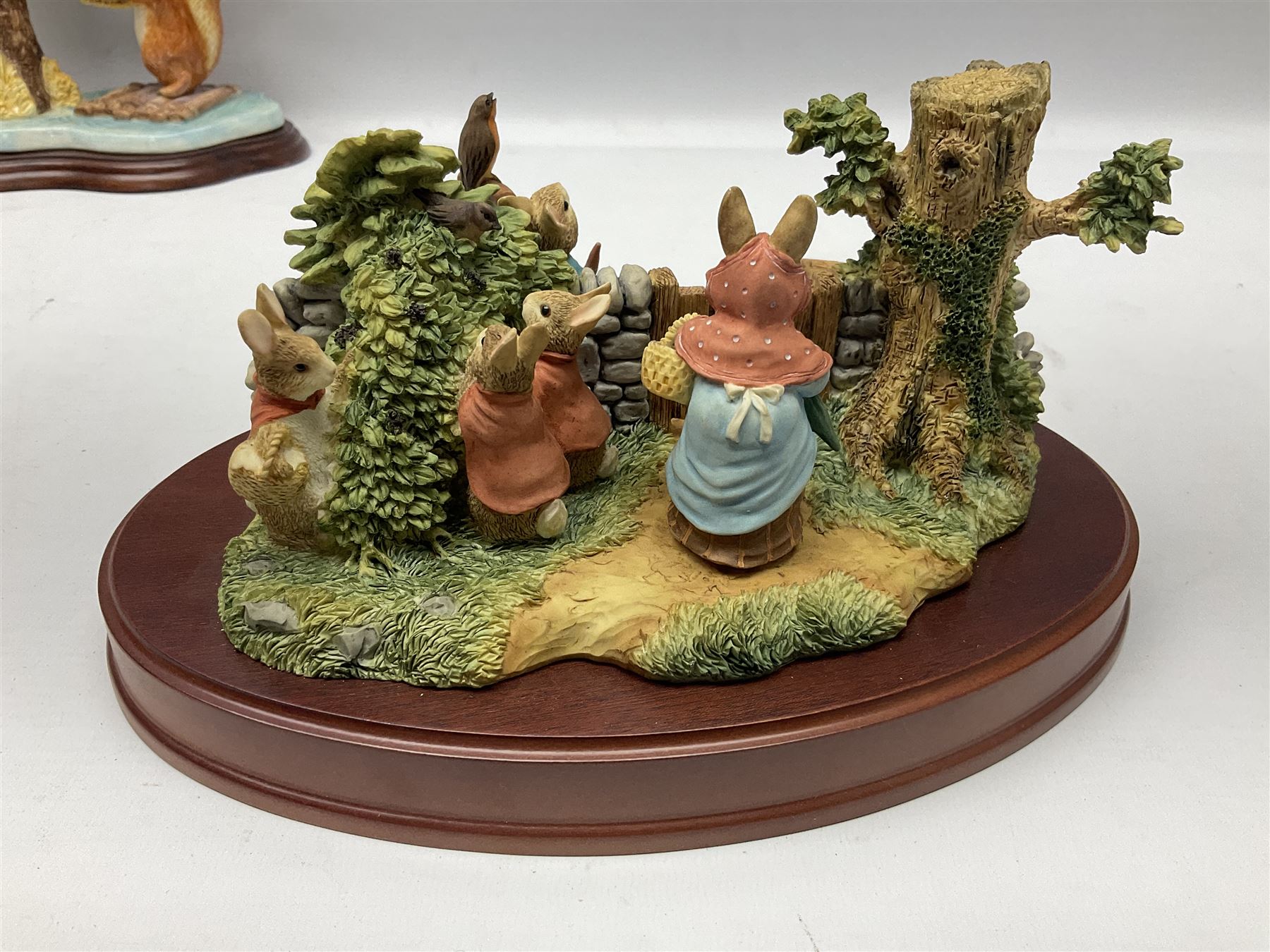 Four Border Fine Arts Beatrix Potter figures, comprising Tableau created to commemorate the Millenium together with a Border Fine Arts Limited Edition no 669814, The Tale of Peter Rabbit Tablet A1306, Four Little Rabbits A2442 and Sailing Home A2443