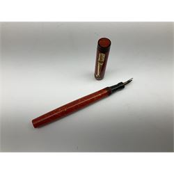 Vintage Swan Mabie Todd lever fill fountain pen in coral red, the nib a/f marked 14K, together with two further vintage Swan Mabie Todd fountain pens, the first example with lever fill, the other leverless, each with black body, one with nib marked 14ct, (3) 