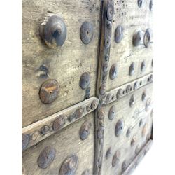 Late 19th century Afghan carved hardwood storage chest, the hinged plank top enclosing large internal storage space, geometric carvings to the front panels decorated with rows of riveted iron bosses