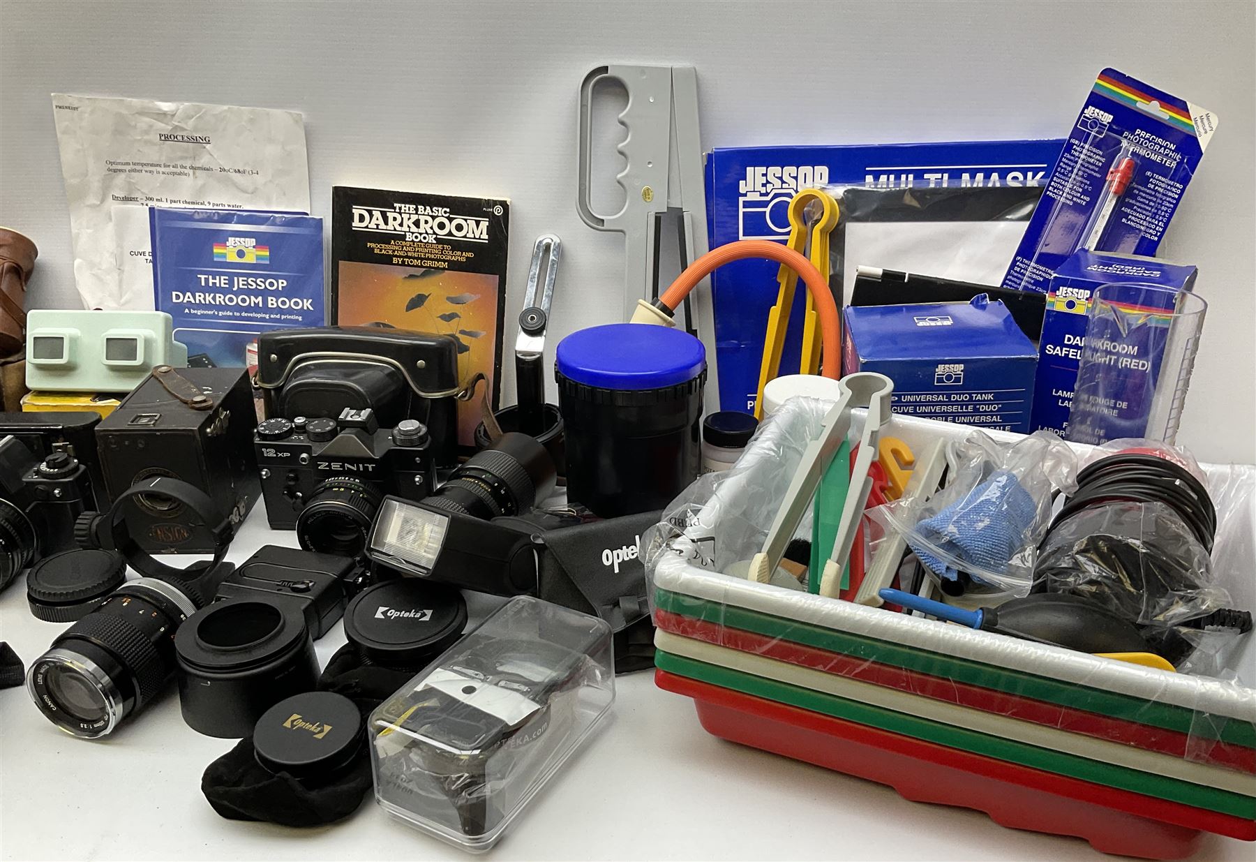 Vintage and later cameras, lenses, accessories and darkroom equipment including Zenit 12XP camera, Praktica BX20 camera fitted with 'Sigma Zoom Master 1:3.5-4.5 f=35-70mm' lens, Praktica LLC camera fitted with 'Carl Zeiss Jena Pancolar 1.8/50' lens, Canon Zoom Lens 'EF 100-300mm 1:5.6', various Jessop and other makers darkroom items including safelight (Red), universal duo tank, multi-mask enlarging easel etc, in three boxes