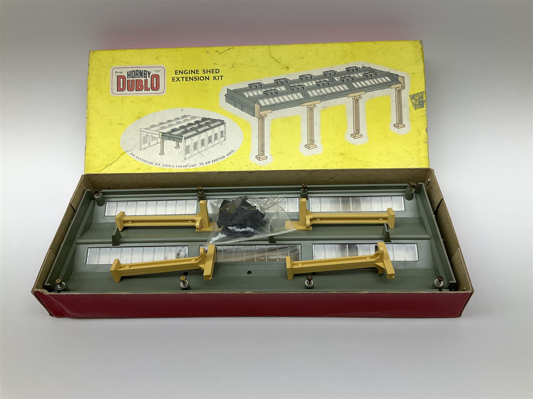 Hornby Dublo - 5006 Engine Shed Extension Kit; 5085 Suburban Station Kit; and 5030 Island Platform Kit; all in pictorial boxes; and Plastic Platform Extension in associated box lid (4)