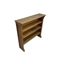 Early 20th century oak bookcase, fitted with four shelves, raised on sledge feet