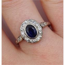 Early 20th century white gold oval sapphire and diamond cluster ring, with diamond set shoulders, stamped 18ct Plat, sapphire approx 0.50 carat