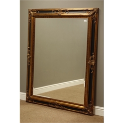  Large rectangular bevelled mirror in black lacquered and gilt frame, 118cm x 149cm  