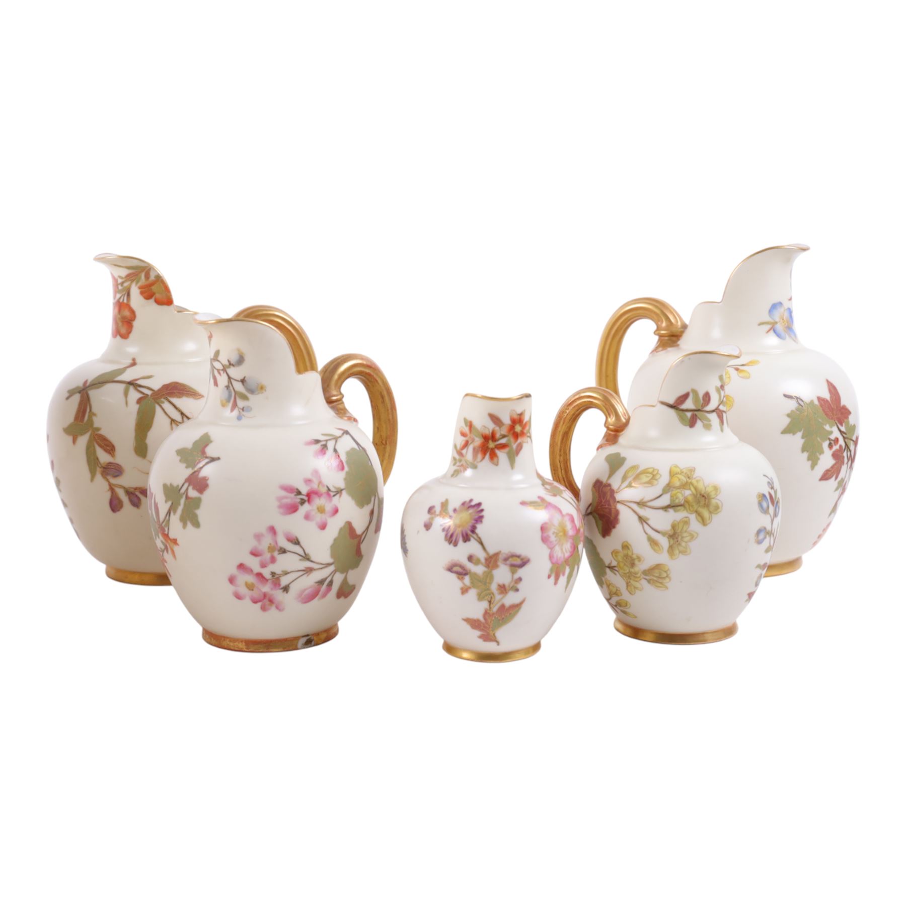 Five Royal Worcester Blush Ivory jugs, shape 1094, each decorated with floral sprigs and with gilt handles , all with puce mark to base, tallest H18cm