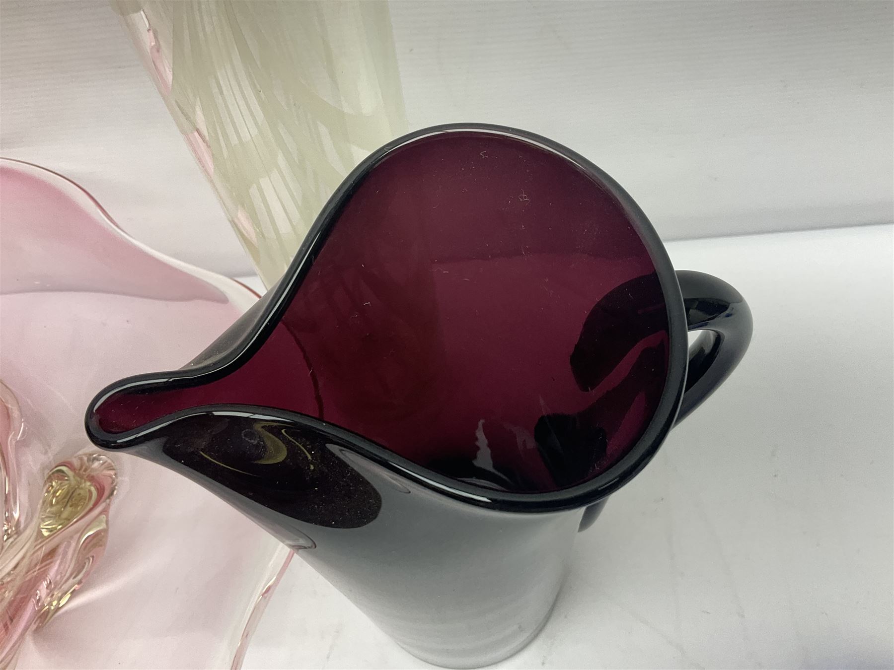 Two Whitefriars glass jugs, together with a Swedish Pukeberg art glass vase and three art glass bowls, including large pink example, some signed to base, tallest H30.5cm