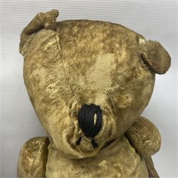 Mid-20th century woodwool filled teddy bear; and porcelain doll dressed as a WW2 evacuee