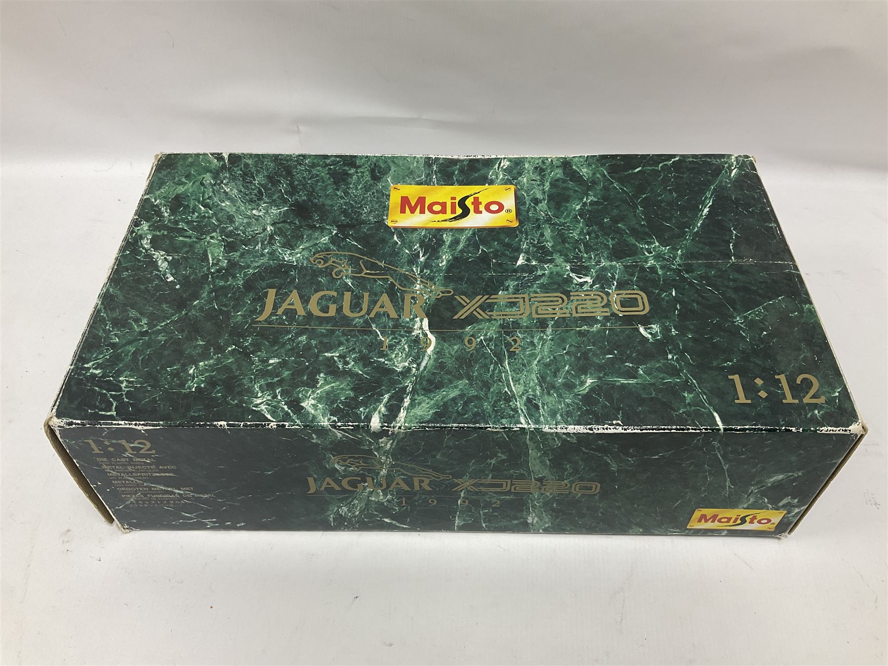 Two Maisto 1:12 scale Jaguar XJ220 ‘Racing’ cars in yellow, both on plinths in original boxes 