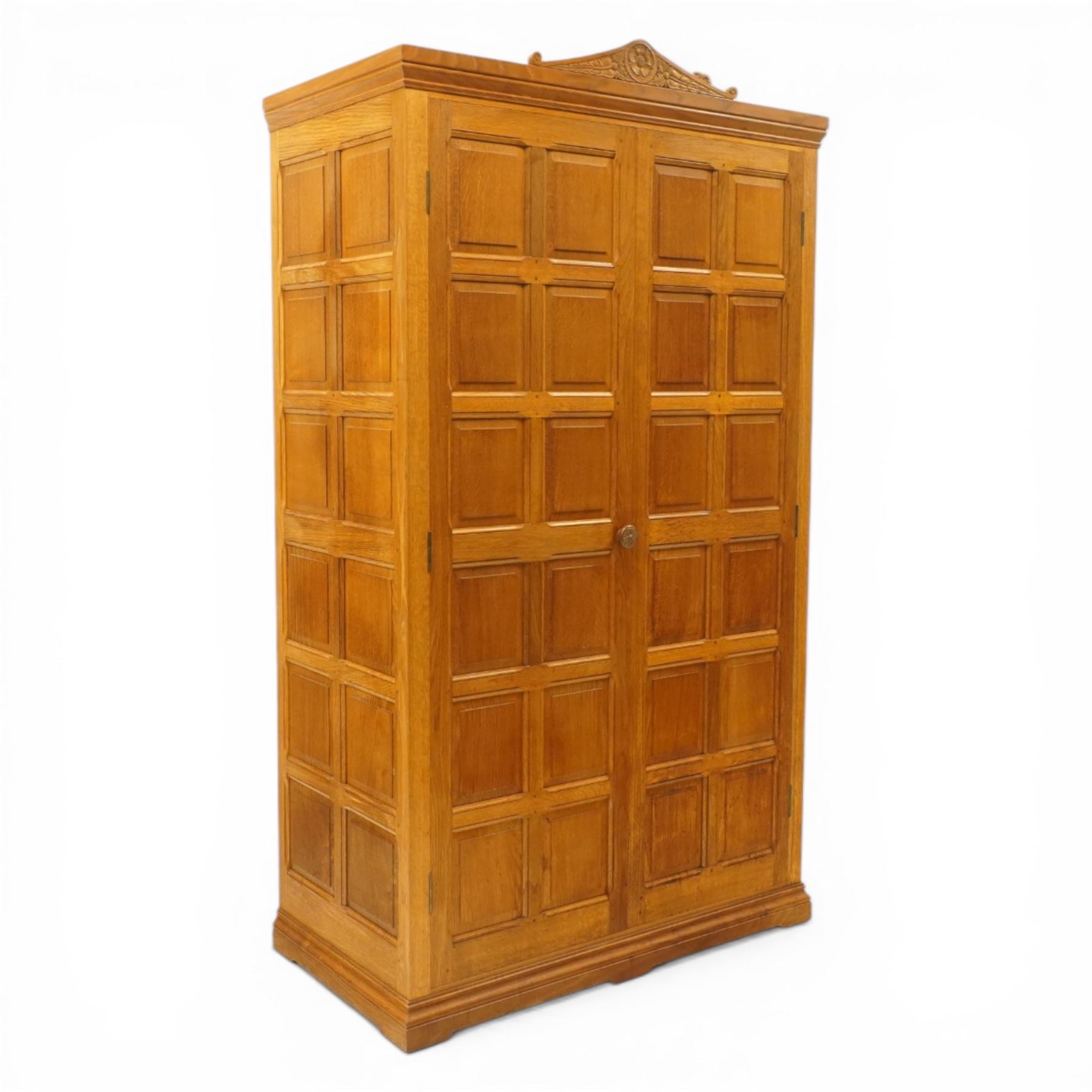 Beaverman - Yorkshire oak panelled double wardrobe, with carved pediment, panelled doors and sides, with internal top shelf above a single hanging rail, with carved beaver signature, by Colin Almack of Sutton near Thirsk