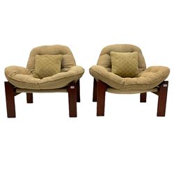 A pair of mid-20th century stained teak framed slung seat chairs, loose buttoned cushions