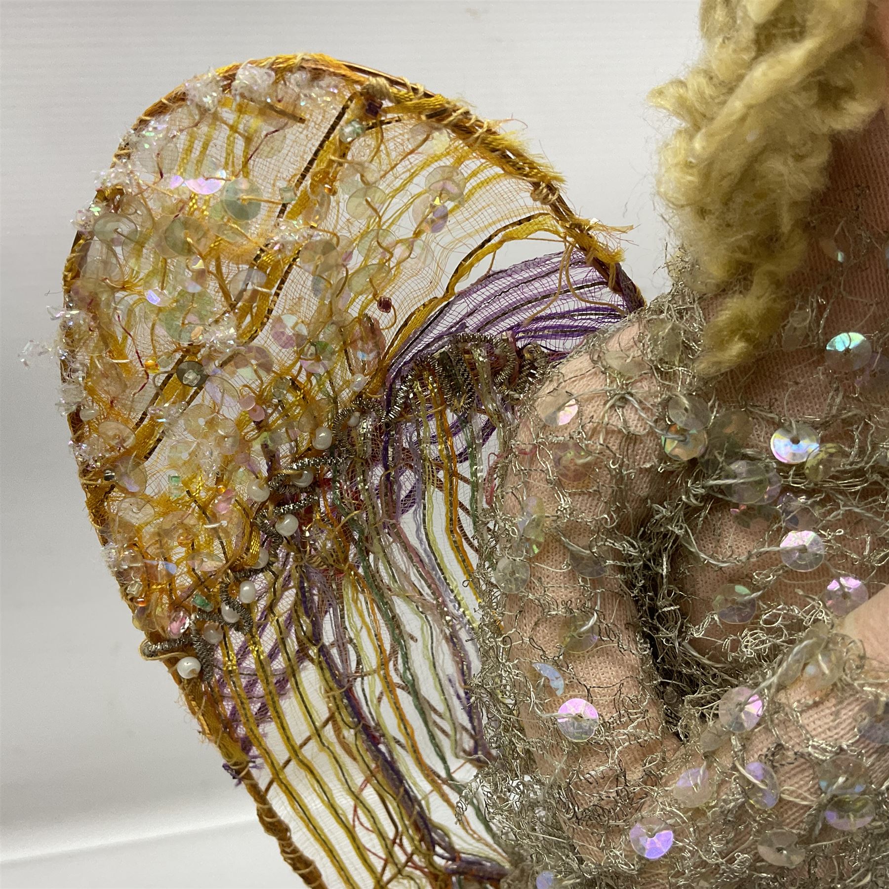 Anna Meszaros Hungary - hand made needlework figurine of an Angel with metallic lace full length dress and open threadwork wings; on moulded base H45cm Auctioneer's Note: Anna Meszaros came to England from her native Hungary in 1959 to marry an English businessman she met while demonstrating her art at the 1958 Brussels Exhibition. Shortly before she left for England she was awarded the title of Folk Artist Master by the Hungarian Government. Anna was a gifted painter of mainly portraits and sculptress before starting to make her figurines which are completely hand made and unique, each with a character and expression of its own. The hands, feet and face are sculptured by layering the material and pulling the features into place with needle and thread. She died in Hull in 1998.