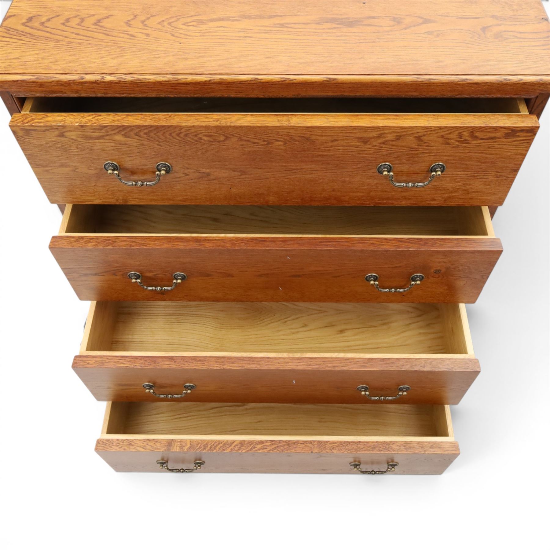 Cabinet-made oak chest, fitted with four soft-close drawers, brass swan neck handles and pierced backplates, on bracket feet