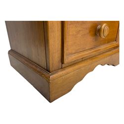 Pair of contemporary cherry wood bedside chests, rectangular top and projecting moulded cornice over three drawers, on plinth base with shaped apron