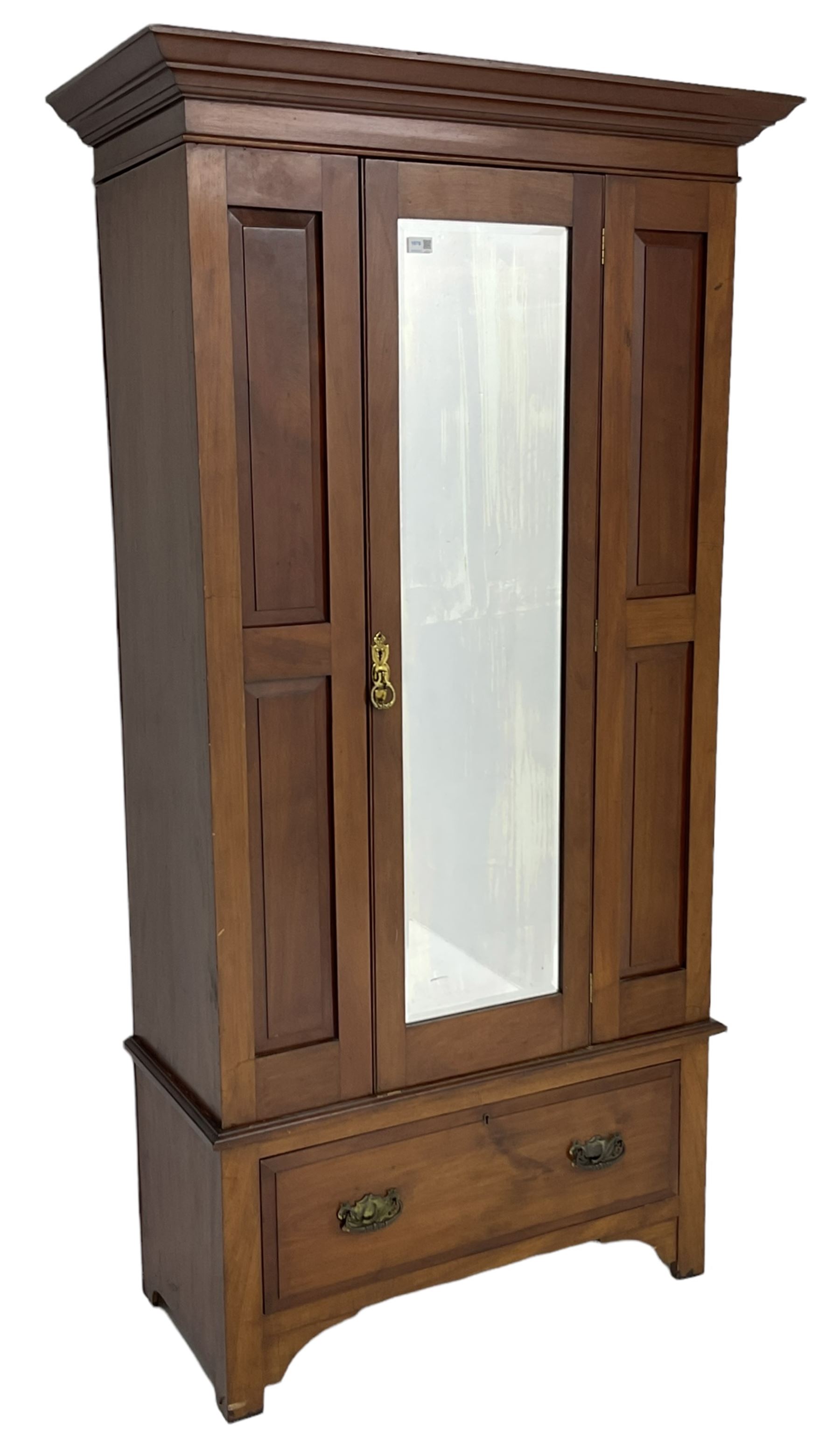 Edwardian walnut single wardrobe, projecting cornice over panelled front and bevelled mirror glazed door, single drawer to base