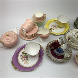  A Wedgwood bone china pink glazed teaset for six, comprising teapot, twin handled sucrier with cover, cream jug, milk jug, small bowl and plate, each with printed mark beneath. Together with a further Wedgwood green glazed part teaset, and other assorted tea wares, including a Newhall Nirvana shape teapot and jug, two lustre teacups with pierced saucers, three Narium teacups and saucers, etc., in wicker basket.   