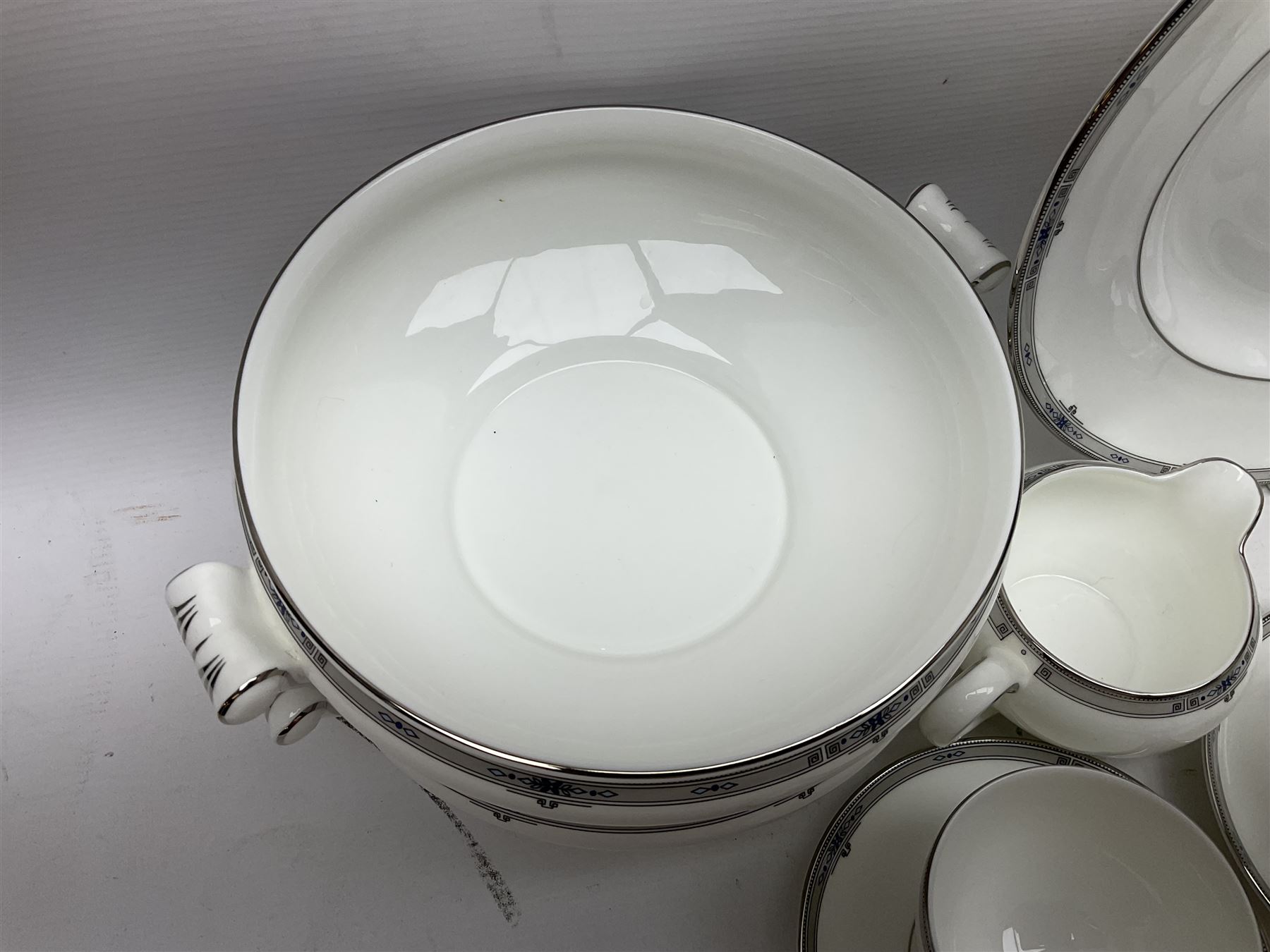 Wedgwood Amherst pattern part tea service, comprising eight cups and saucer, sixteen dessert plates, milk jug, covered sucrier, together with matching platter and two open serving dishes