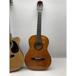 Ramon acoustic cut-away guitar, model no.4103C L103cm; and Stagg acoustic guitar, model C546 PACK, serial no.0504/314 with footrest L99cm; each in soft carrying case with accessories (2)