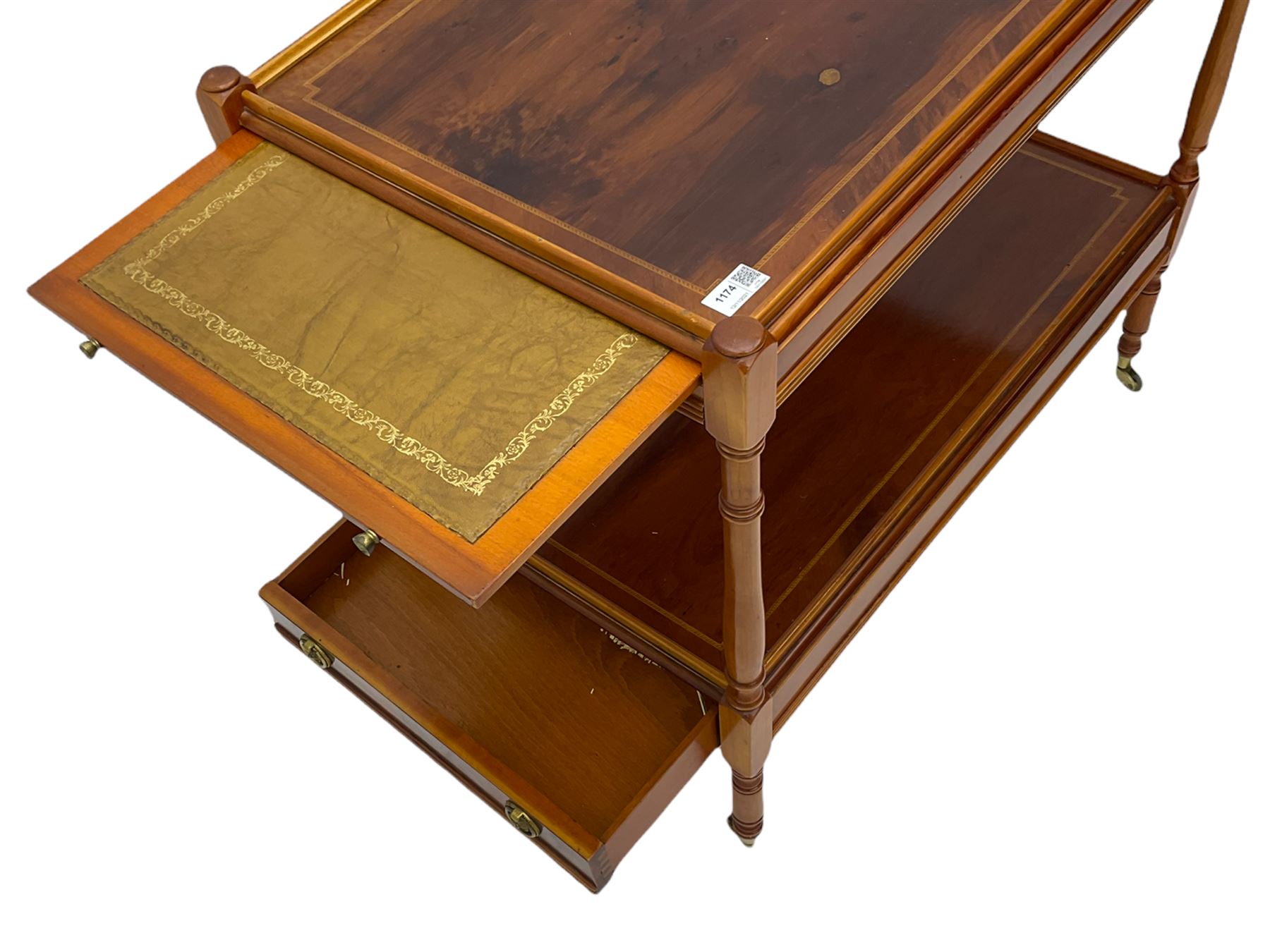 Yew wood drinks trolley, rectangular form with leather inset slide and turned handle, the undertier fitted with drawer, turned supports and brass castors
