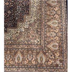 Large Persian indigo ground rug, the busy field decorated with trailing branches and flower heads, peach border decorated with palmettes -