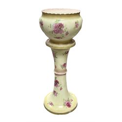 An early 20th century ceramic jardiniere on stand, each decorated with pink roses upon a yellow ground, overall H93cm.