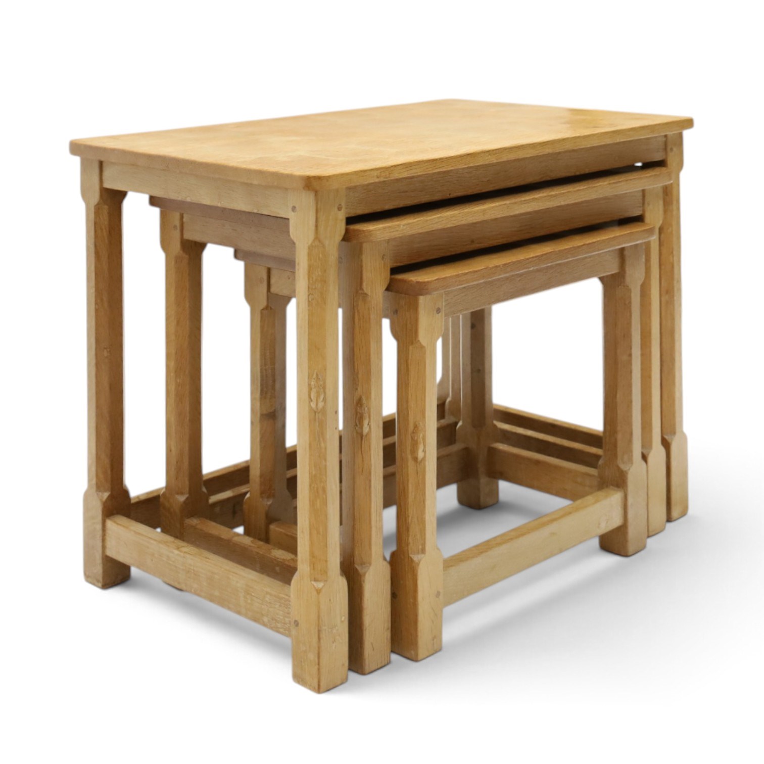 Mouseman - nest of three oak occasional tables, rectangular adzed top, on octagonal supports united by plain stretchers, each carved with mouse signature, by the workshop of Robert Thompson of Kilburn