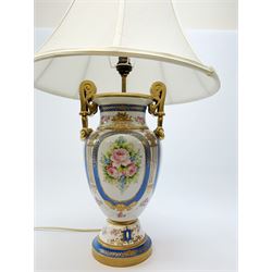 A Sevres style table lamp, of baluster form with twin gilt scroll handles, the body decorated with hand painted flowers contained within blue borders, and heightened in gilt, with cream fabric shade, overall H62cm.