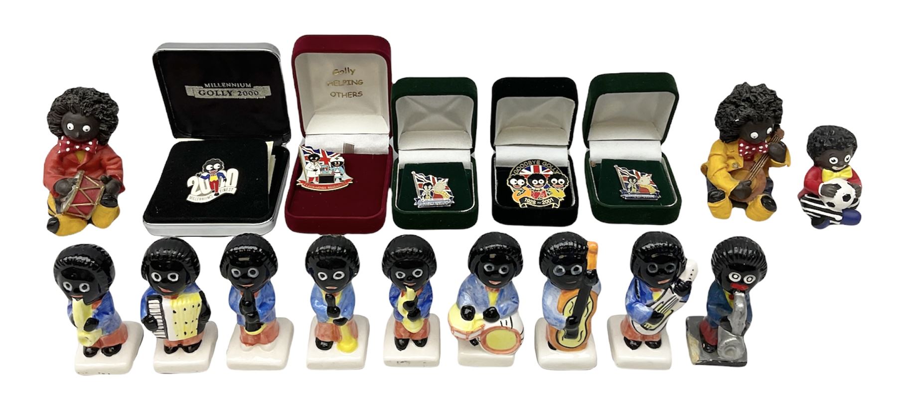 Eight ceramic Golly Band figurines marked Carlton Ware, together with four other Golly figures and five boxed badges