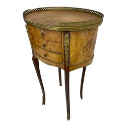 Late 20th century French design figured elm and bedside table, raised pierced gilt metal gallery over oval top, fitted with three mahogany lined drawers flanked by gilt metal mounts of female mask and foliate form, on cabriole supports