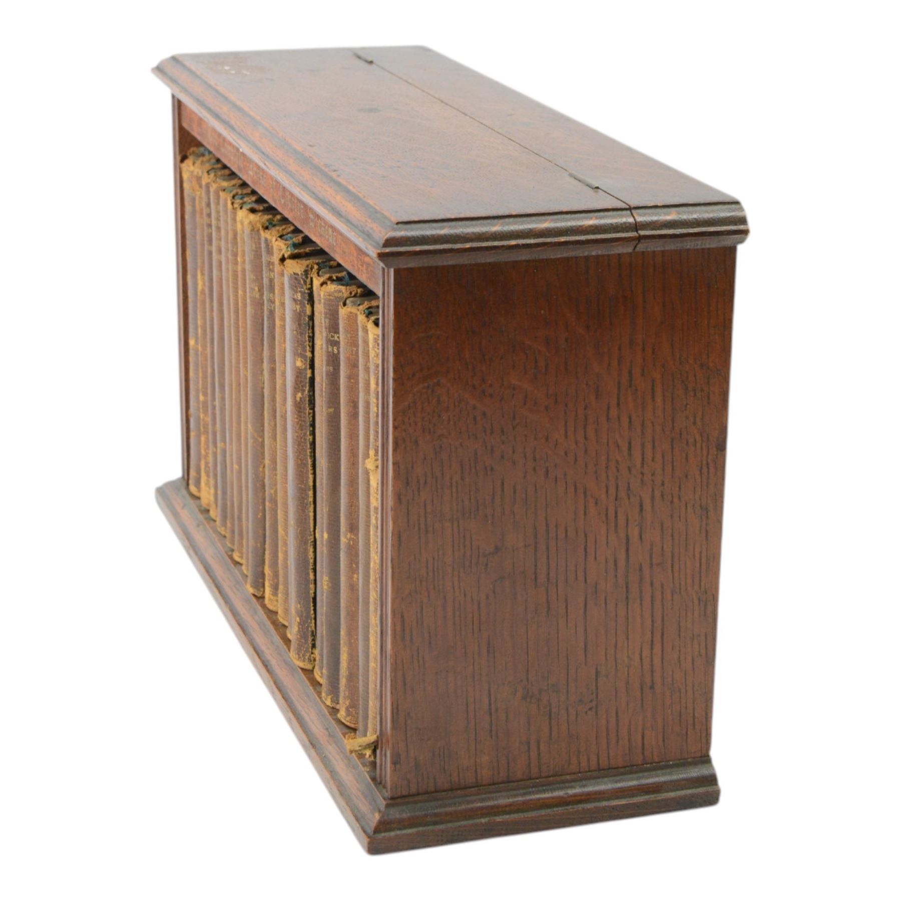 Dickens Charles, The Complete Works of Charles Dickens, 17 Vols, illustrations by 'Phiz', London, Chapman & Hall, Limited; and Henry Frowde, New York; Oxford University Press American Branch, later replaced boards, housed within an oak table top bookcase, with hinged lid, titled 'The Complete Work of Charles Dickens', together with a number of other books

