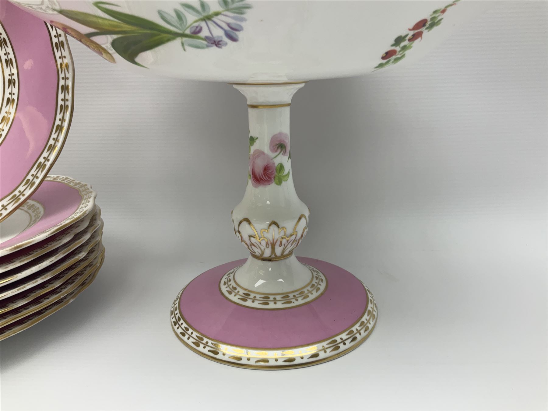 Victorian Copeland, Botanical dessert service, decorated with floral sprigs to the centre with a pink and gilt border, comprising five comports and seven plates, largest comport H20cm, plate D22cm