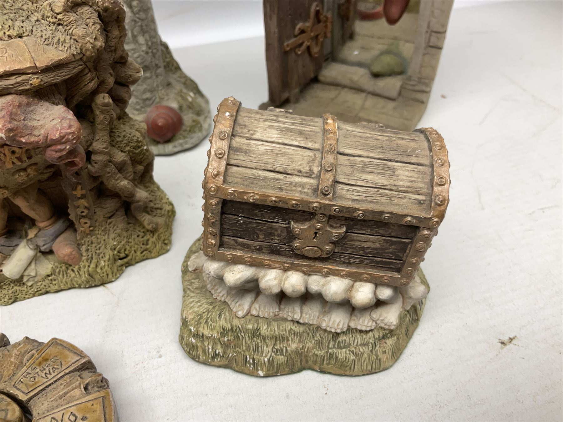 Seven Terry Pratchett Discworld figures by Clarecraft, to include The Luggage DW04M Smugli D990, pair of Home Sweet Home bookends, wall hanging modelled as a dragon upon stone plinth etc, tallest H19cm