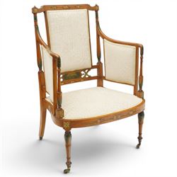 Pair of Victorian Sheraton Revival painted satinwood armchairs, the cresting rail painted with trailing floral bouquets flanked by illusion arcade motifs, over a cameo back and sides with acanthus painted swell-turned uprights, the lower back rail decorated with a bird scene and flanking pierced foliate design, upholstered in ivory fabric, raised on turned supports with further acanthus leaf paintwork, terminating to brass castors